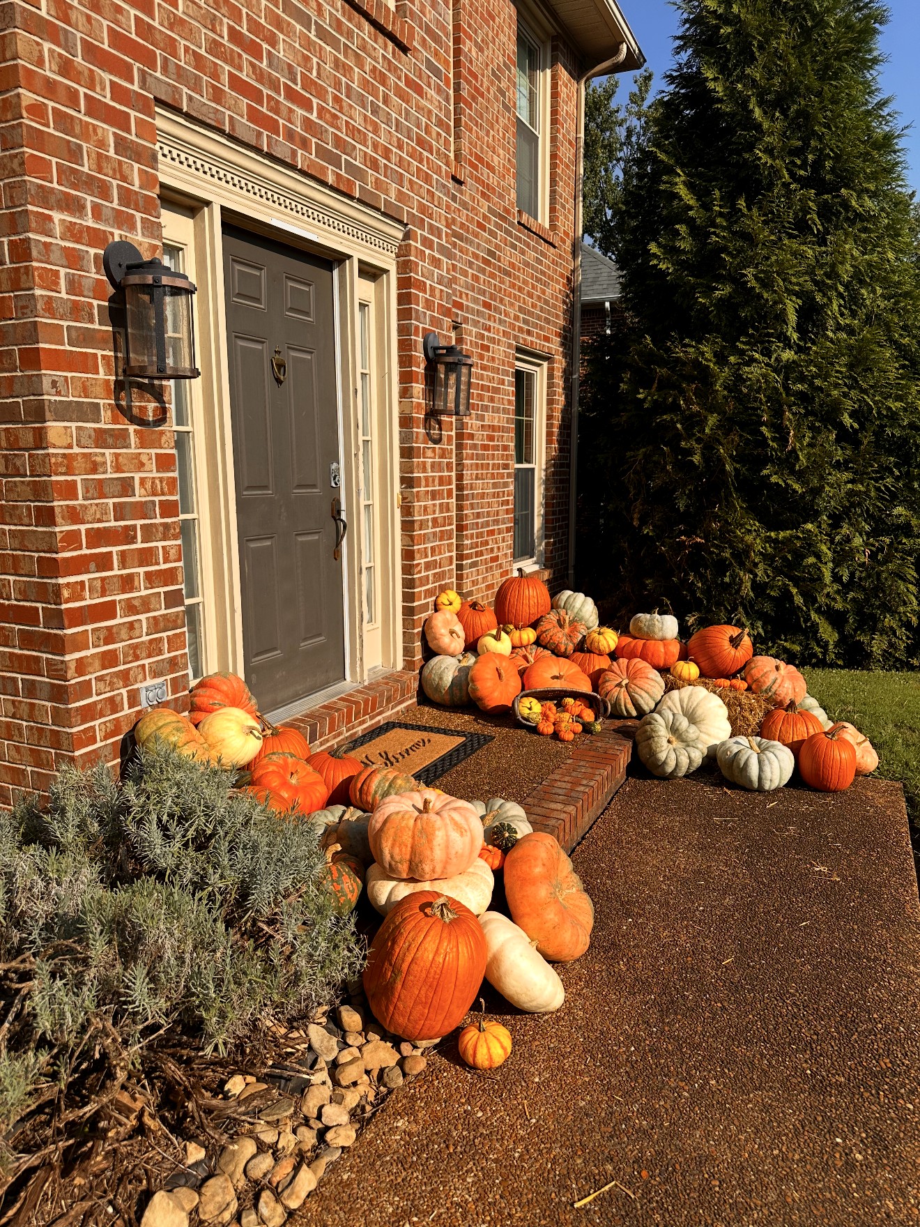 Brick home entry styled with heirloom pumpkins